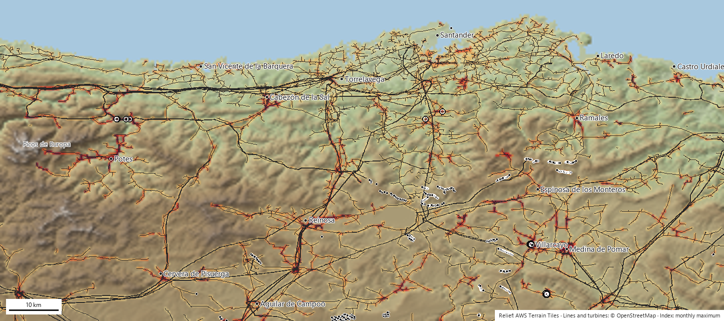 Annual risk index in Cantabria: cells coloured from yellow to dark red over a shaded relief map with the power lines in grey
